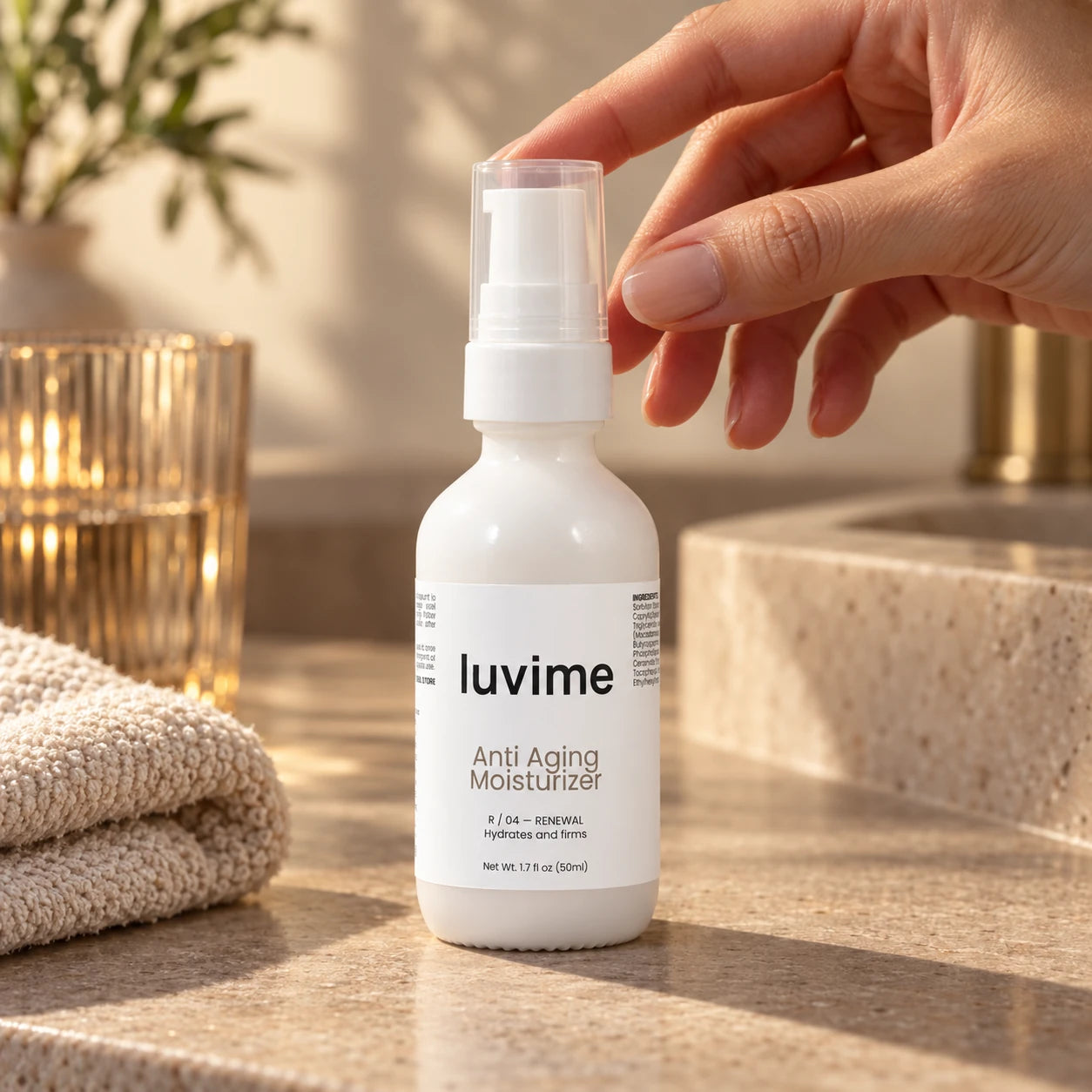 Luvime Anti Aging Moisturizer on a warm stone vanity with a hand and soft afternoon light